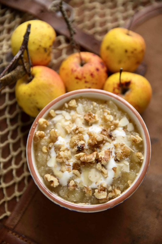 Stewed Windfalls With Hollis Mead Yoghurt And Walnuts in front of 5 apples