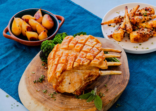 French Trimmed Rack Of Pork With Roasted Pears And Cheese Crumbed Parsnips