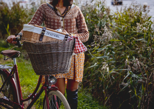 woman pusing bike with dukeshill picnic hamper